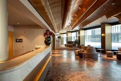 a lobby of a hotel with a waiting area and chairs at Hotel Walhalla in St. Gallen