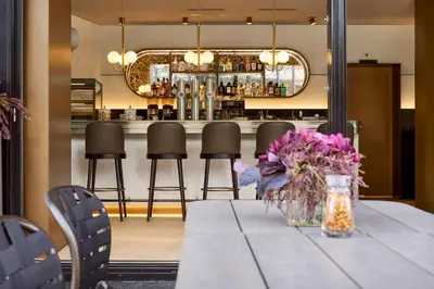a table with a vase of flowers on it at Hotel Walhalla in St. Gallen