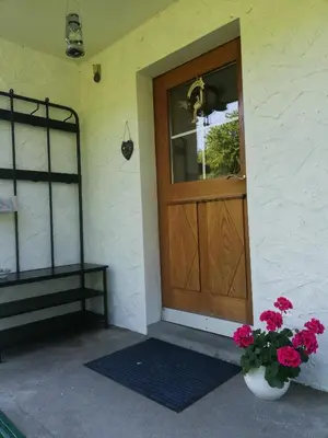 a front door of a house with a vase of flowers at Billenberghof in St. Gallen