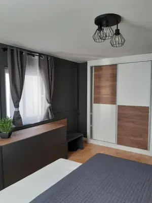 a bedroom with a bed and a black wall at Rome Apartment in Rheineck