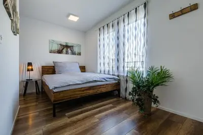 a bedroom with a bed and a window at Aparthotel Mama Home Arbon in Arbon