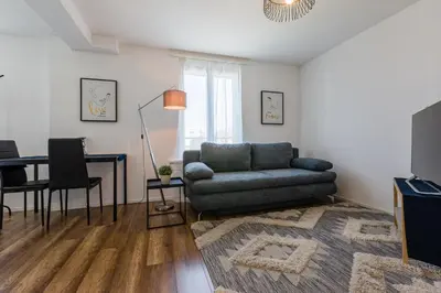 a living room with a couch and a table at Aparthotel Mama Home Arbon in Arbon