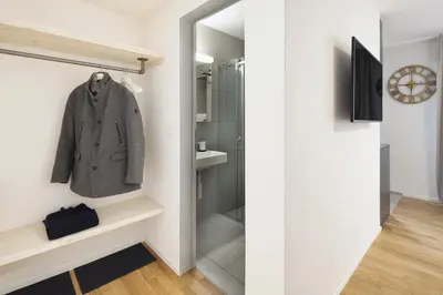 a small bathroom with a walk in shower at VISIMO Apartments Lehnstrasse St Gallen - Stylish, Smart, Connected in St. Gallen