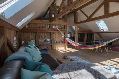 a living room with a couch and a hammock at NEU renoviert - Bitzi Appenzell – Mit Aussicht in Appenzell