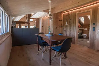 a dining room with a wooden table and chairs at NEU renoviert - Bitzi Appenzell – Mit Aussicht in Appenzell