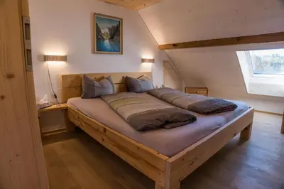 a bedroom with a large bed in a attic at NEU renoviert - Bitzi Appenzell – Mit Aussicht in Appenzell