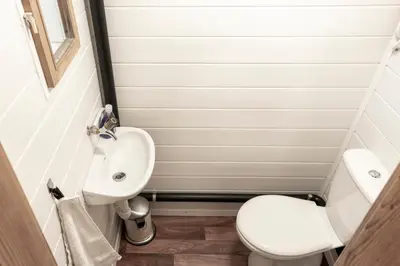 a small bathroom with a toilet and a sink at Villa Donkey Ferienwohnung 113 in Degersheim