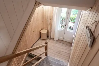 a staircase in a tiny house with a door at Villa Donkey Ferienwohnung 113 in Degersheim