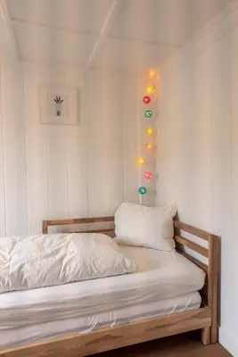 a bedroom with a bed with lights on the wall at Villa Donkey Ferienwohnung 113 in Degersheim