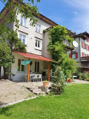 a house with a patio and a table in the yard at Villa Donkey Ferienwohnung 113 in Degersheim