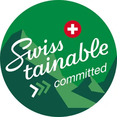 a green sign with a red cross and the words cruise tauntedumed at flexymotel Buchs in Buchs