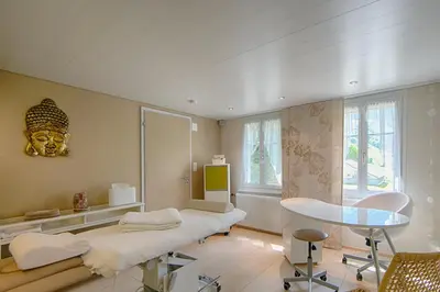 a room with a bed and a table and a mirror at Hotel Frohe Aussicht in Weissbad