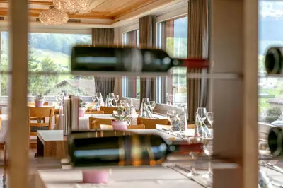 two bottles of wine on a table in a restaurant at Hotel Frohe Aussicht in Weissbad