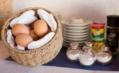 a basket of eggs and milk on a table at Hotel Metropol in Widnau