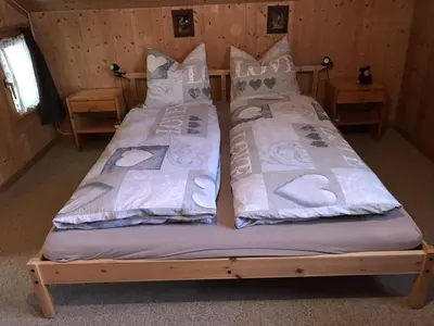 two beds in a room with two pillows at Appenzellerland - Ferienhaus 