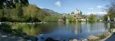 a lake with a castle in the middle of it at BoHo by Maier - kontaktloser Check-In in Buchs