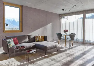 a living room with a couch and a table at BoHo by Maier - kontaktloser Check-In in Buchs