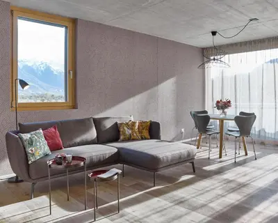a living room with a couch and a table at BoHo by Maier - kontaktloser Check-In in Buchs