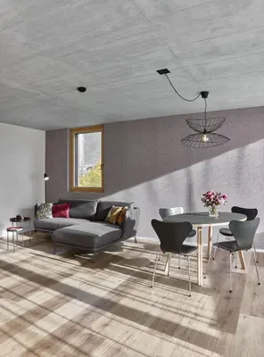 a living room with a couch and a table at BoHo by Maier - kontaktloser Check-In in Buchs