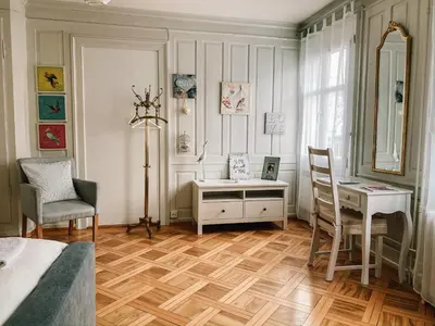 a bedroom with a desk and a bed and a table at CityLodge St Gallen - 2 min to Marktplatz in St. Gallen