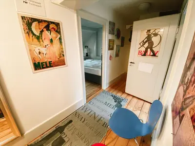 a small room with a blue chair and a door at CityLodge St Gallen - 2 min to Marktplatz in St. Gallen