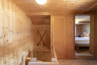 a wooden room with a clock on the wall at Sigerst in Wildhaus