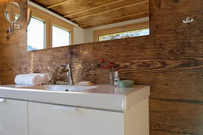 a bathroom with a white sink and a mirror at Sigerst in Wildhaus