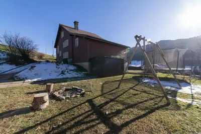 a swing set in a yard with a house at Sigerst in Wildhaus