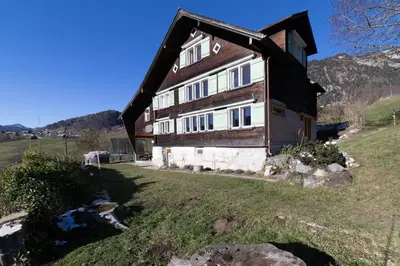 a house on top of a hill with a yard at Sigerst in Wildhaus