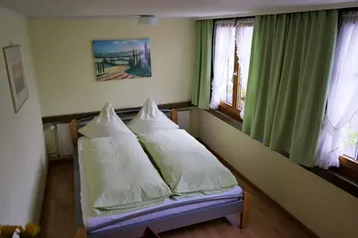 a bedroom with a bed with pillows on it at Hotel Linde Goldach in Goldach