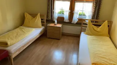 a bedroom with two beds and a window at Hotel Linde Goldach in Goldach