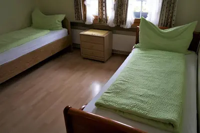 two beds in a small room with at Hotel Linde Goldach in Goldach