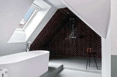 a bathroom with a black and white patterned wall at Sorell Boutique-Hotel City Weissenstein St Gallen in St. Gallen
