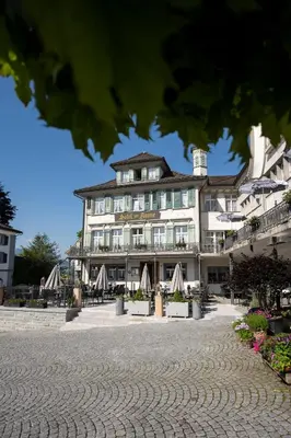 a large building with a courtyard in front of it at Hotel Krone Gais in Gais