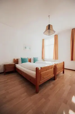 a bedroom with a large wooden bed in a room at Hotel Krone Gais in Gais