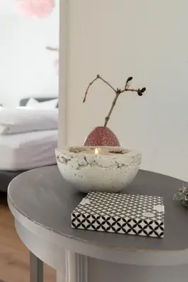 a bowl on a table with a candle on it at Panorama Blick in Unterwasser