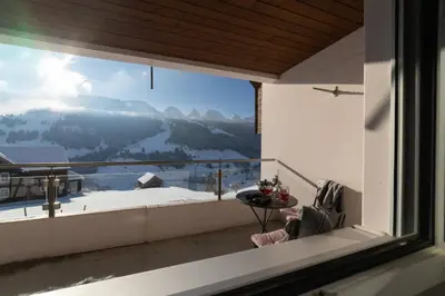 a room with a window with a view of a mountain at Panorama Blick in Unterwasser