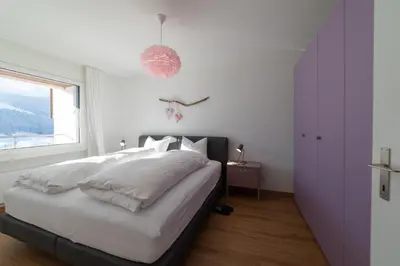 a bedroom with a bed with white sheets and a window at Panorama Blick in Unterwasser