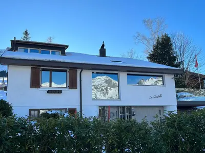 a house with snow on the windows of it at Ski-InOut 4BR Alpen Chalet, Views & Fire in Alt Sankt Johann
