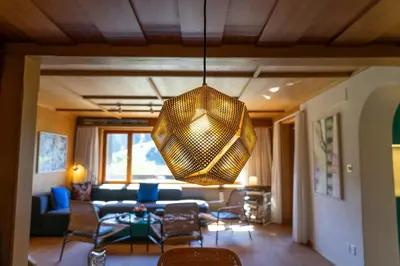 a living room with a couch and a chandelier at Etienne in Wildhaus