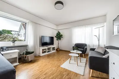 a living room with a couch and a tv at SOHO 1A !Gratis Parken, Free Parking! in Kreuzlingen