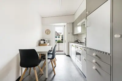 a kitchen with a table and two chairs at SOHO 1A !Gratis Parken, Free Parking! in Kreuzlingen