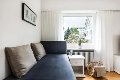 a couch in a living room with a window at SOHO 1A !Gratis Parken, Free Parking! in Kreuzlingen