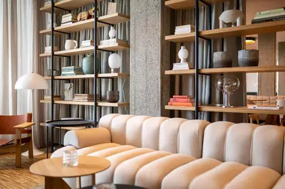 a living room with a couch and tables and shelves at Hotel Heiden - Wellness am Bodensee in Heiden