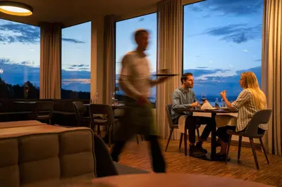 a group of people sitting at a table in a restaurant at Hotel Heiden - Wellness am Bodensee in Heiden