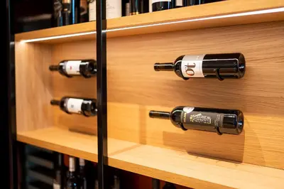 a wooden shelf with bottles of wine on it at Hotel Heiden - Wellness am Bodensee in Heiden