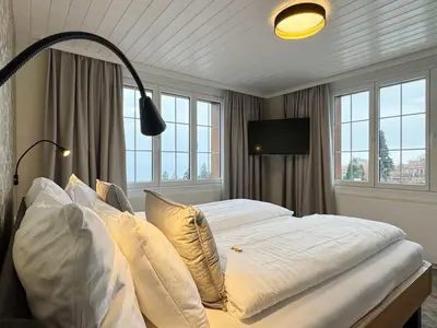 a bedroom with a bed with white sheets and pillows at Best Western Hotel Rebstock in Rorschacherberg