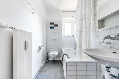 a white bathroom with a sink and a toilet at SOHO 9 !Gratis Parken, Free Parking! in Kreuzlingen