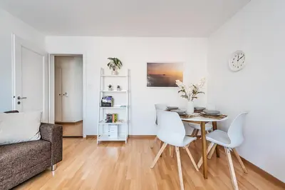 a living room with a table and chairs at SOHO 9 !Gratis Parken, Free Parking! in Kreuzlingen