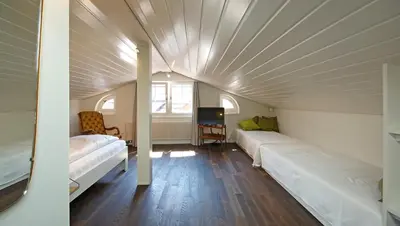 a room with two beds and a room with a ceiling at Alte Metzg - Boutique Pension in Appenzell